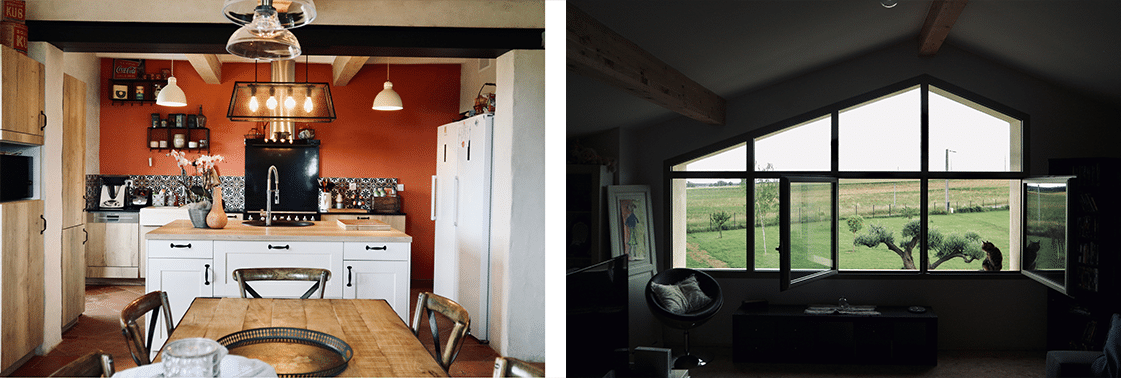Cuisine ouverte aux murs terracotta avec grande table conviviale, et séjour coiffé d'une charpente cathédrale ouvert sur la campagne par une baie triangulaire